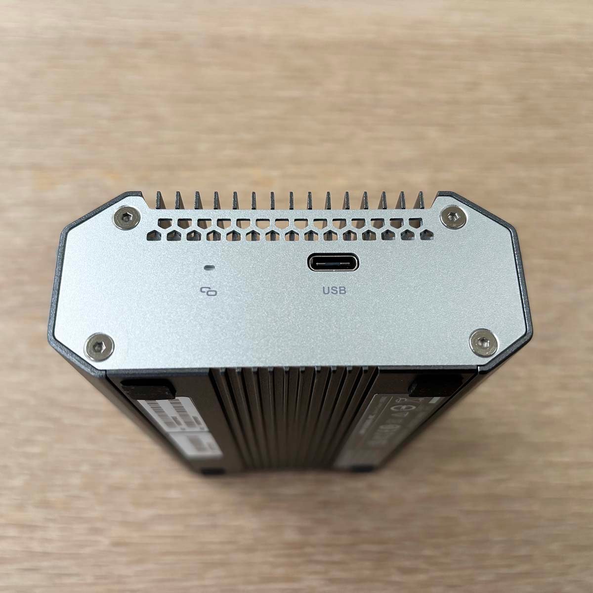 A picture of the QNAP USB to Ethernet adapter with USB and power.