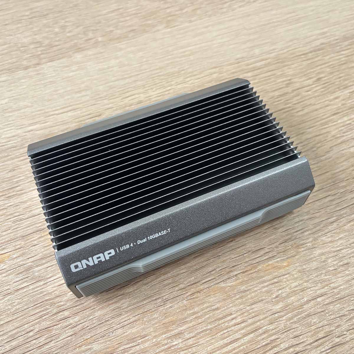 A picture of the QNAP USB to Ethernet adapter.