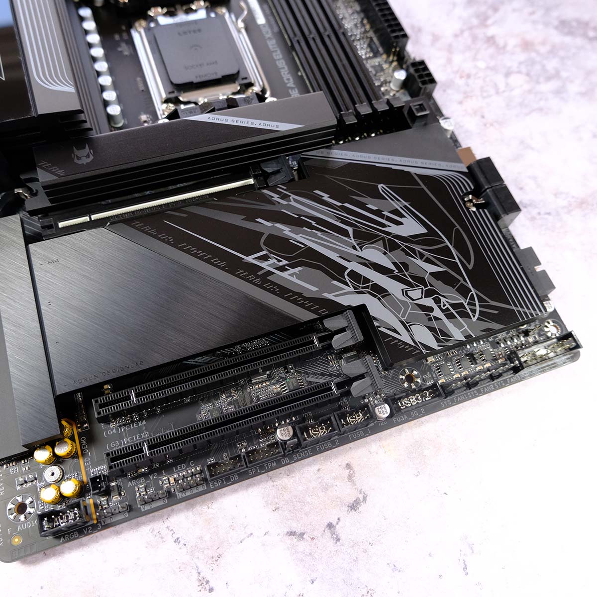 The lower portion of Gigabyte X870E Aorus Elite X3D, showcasing the motherboard's large heatsink for M.2 storage.