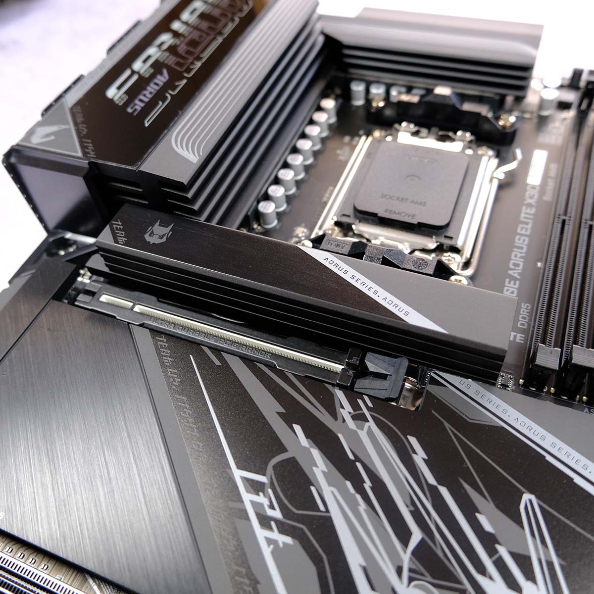 A close up of the primary heatsink and expansion slot for Gigabyte X870E Aorus Elite X3D, showcasing the motherboard's 'PCIe Armor' and cooling.