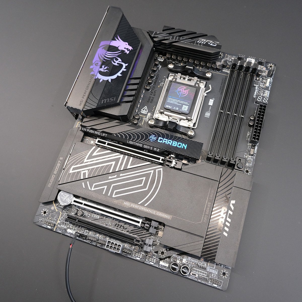 Top-down shot of MPG X870E Carbon Max WiFi motherboard.