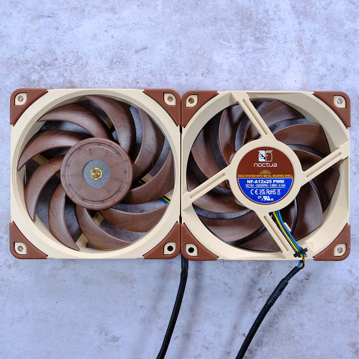 A top-down view of NF-A12x25 PWM, showcasing the front (left) and rear (right) of the fan.