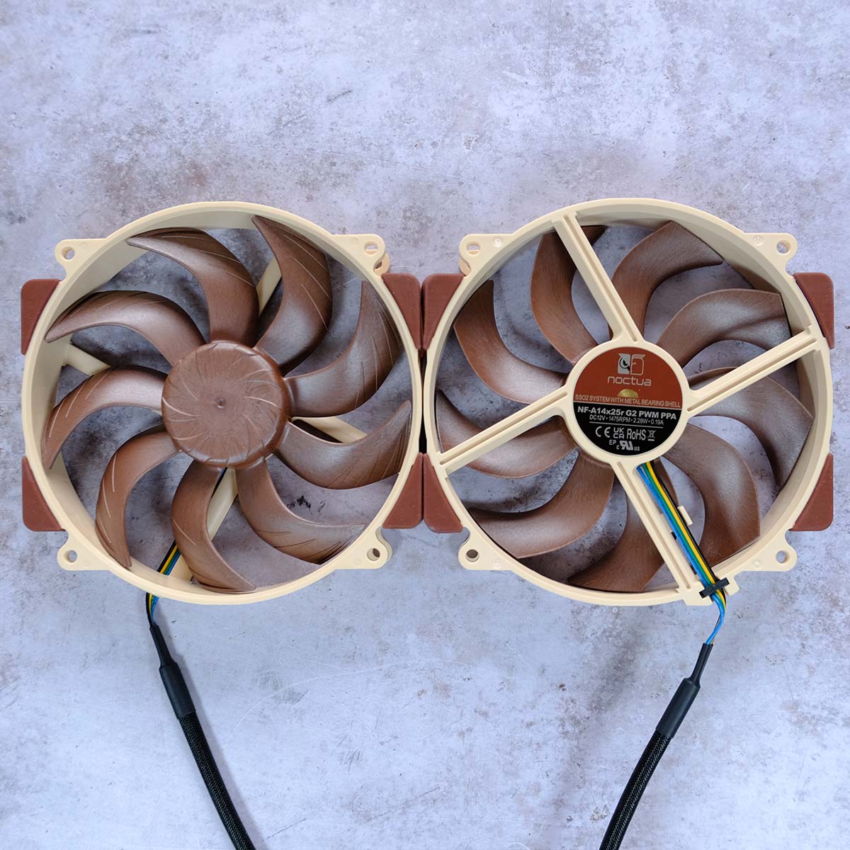 A top-down view of NF-A14x25r G2 PWM, showcasing the front (left) and rear (right) of the fan.