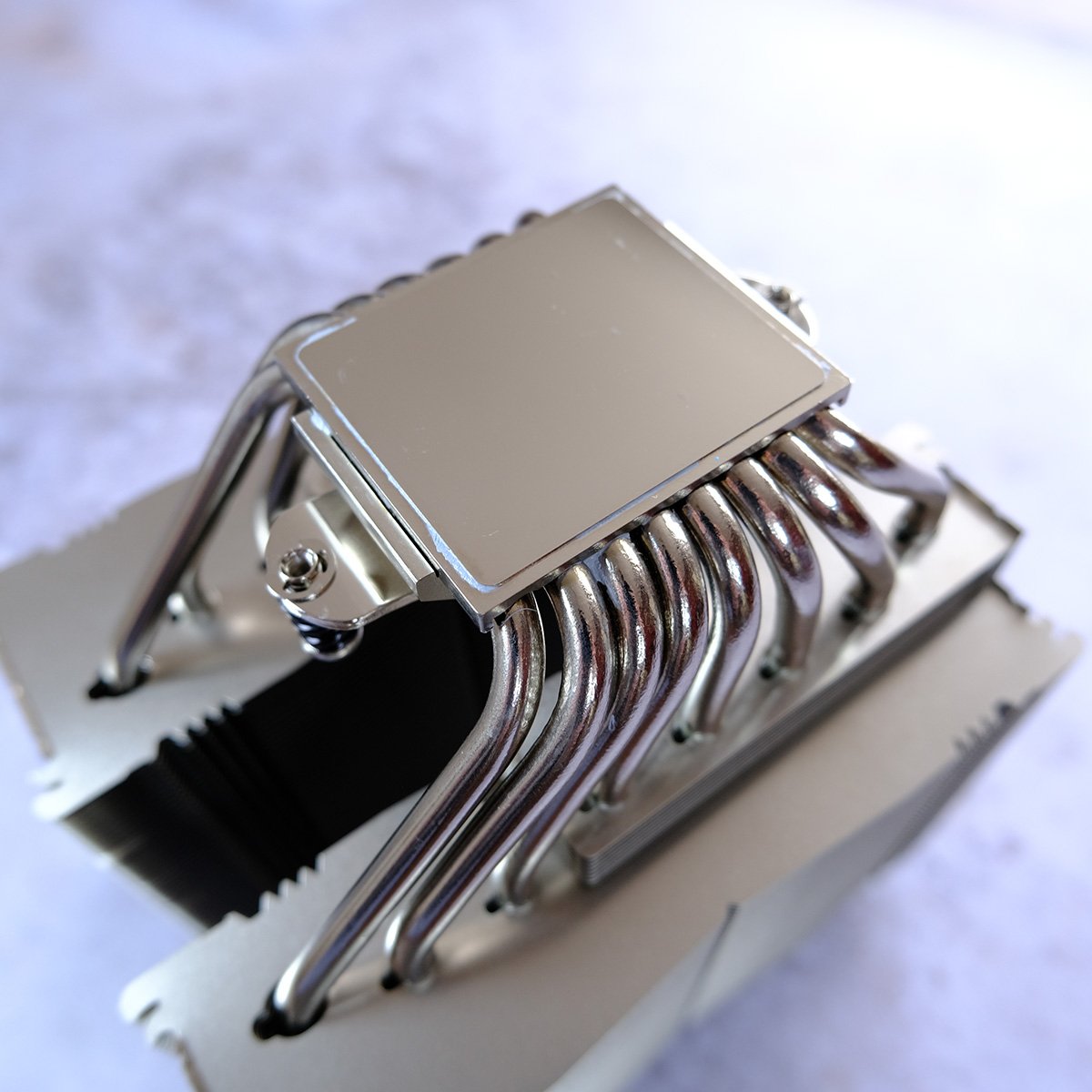 Close up of NH-D15 G2 LBC base, showcasing several heatpipes and two stacks of aluminium fins.