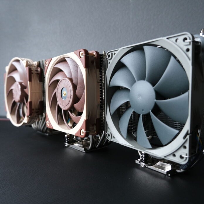 Three Noctua coolers, NH-D15 G2 LBC (left), NH-U12A (centre), and NH-U12S Redux (right) stand upright, their fans facing away from the camera.