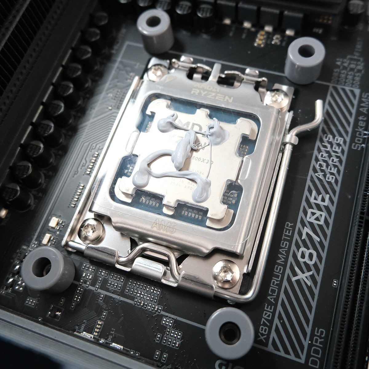 Close up of 'NA-TPG1' applied to Ryzen 7 9800X3D, covered in thermal paste.