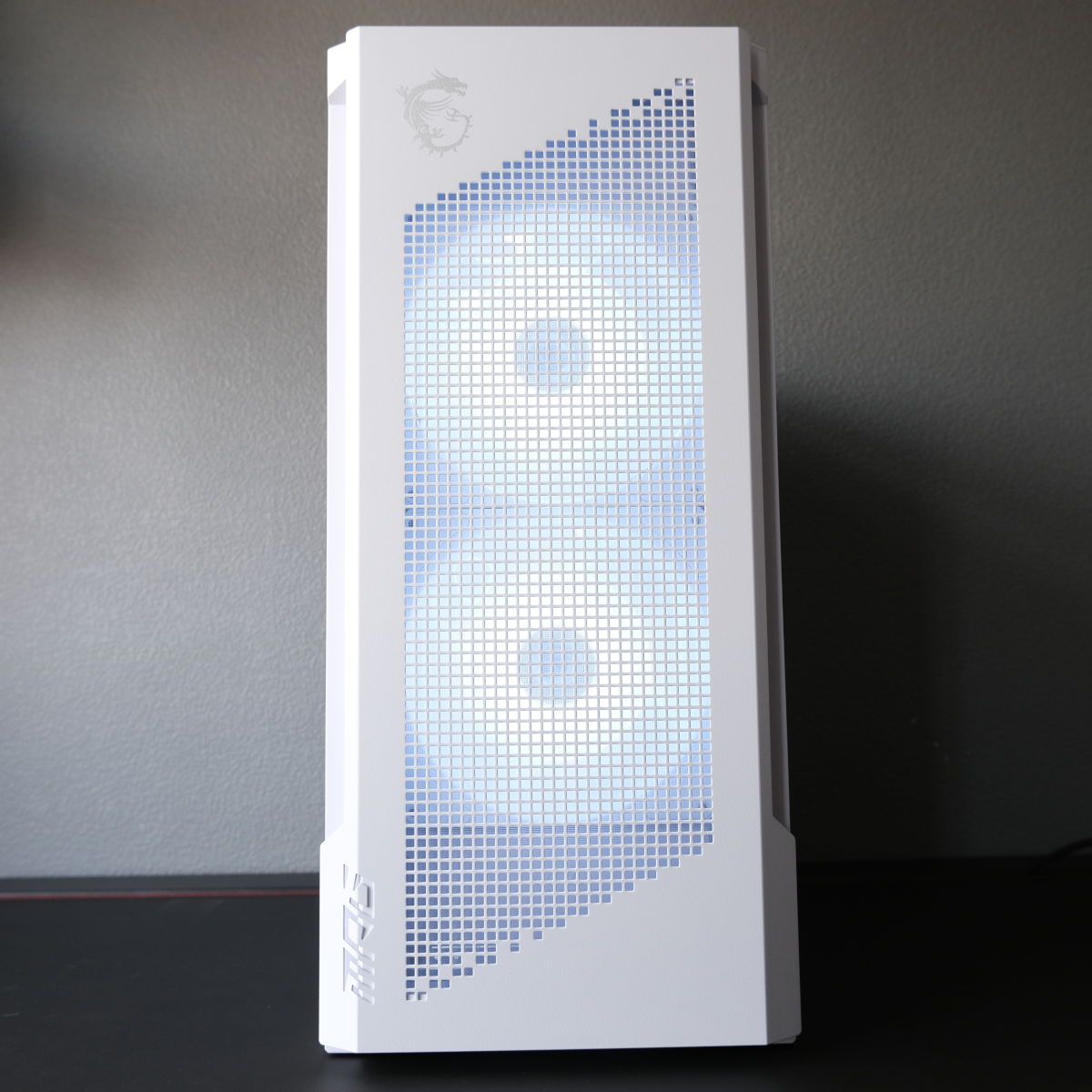 A front view Novatech Reign Sentinel, the system's dual 160mm fans shining brightly through the ventilation cutout.