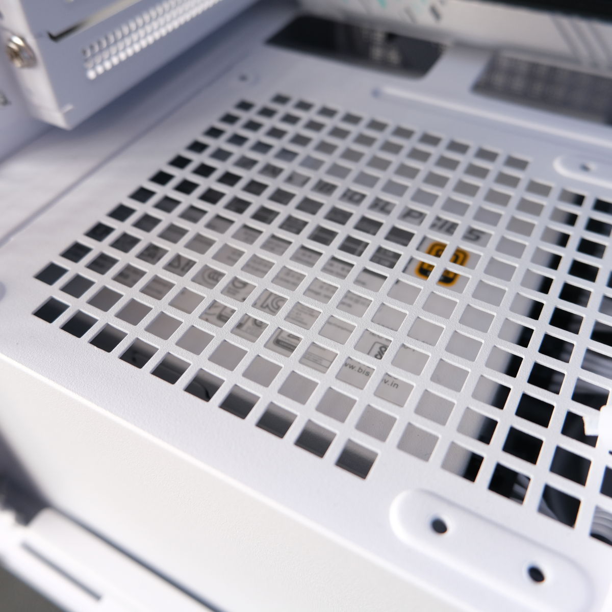 A close up of the PSU shroud, MAG A850GL PCIe5 White is visible through the grate.