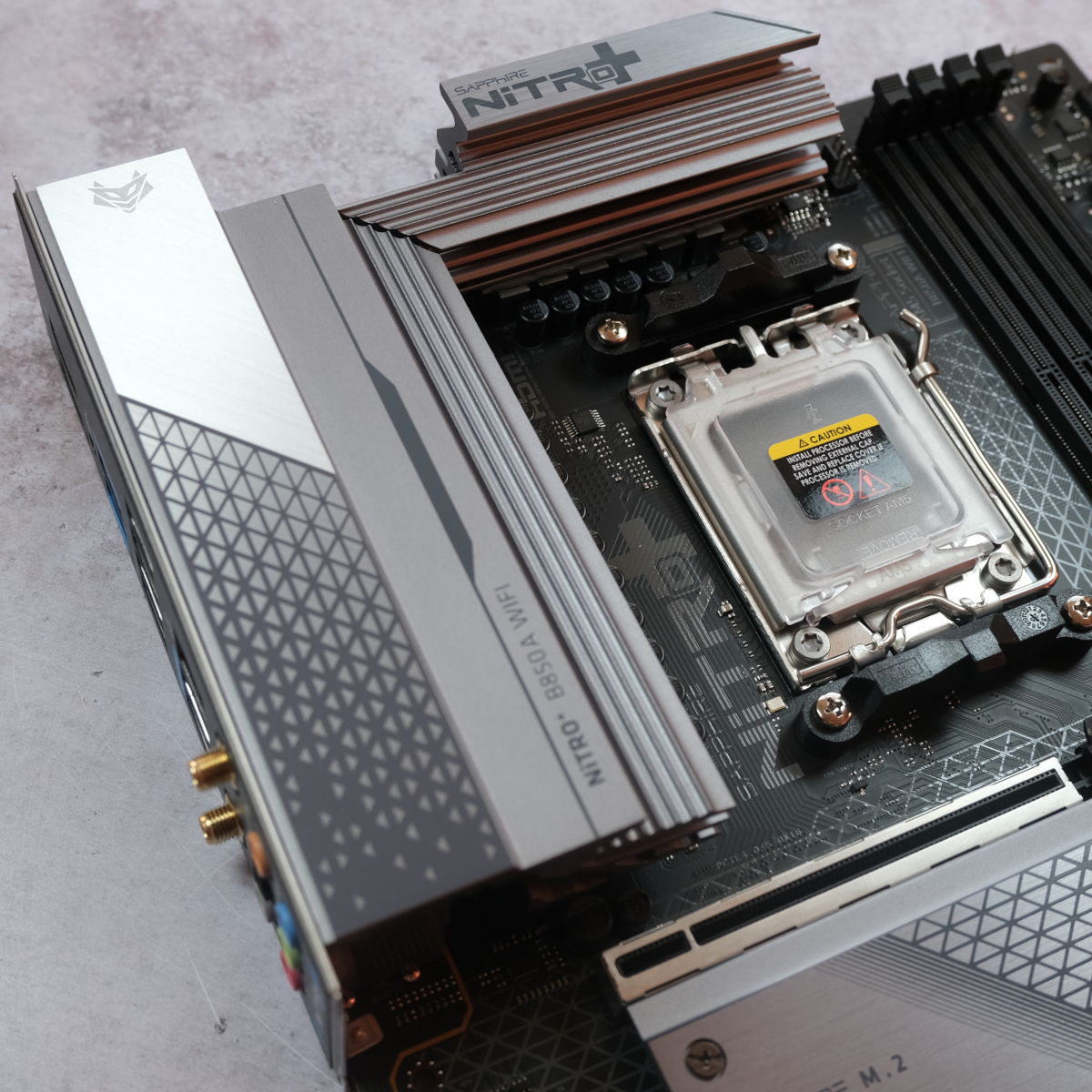 A close up of Sapphire Nitro+ B850A WiFi 7, focussing on the motherboard's VRM heatsinks.