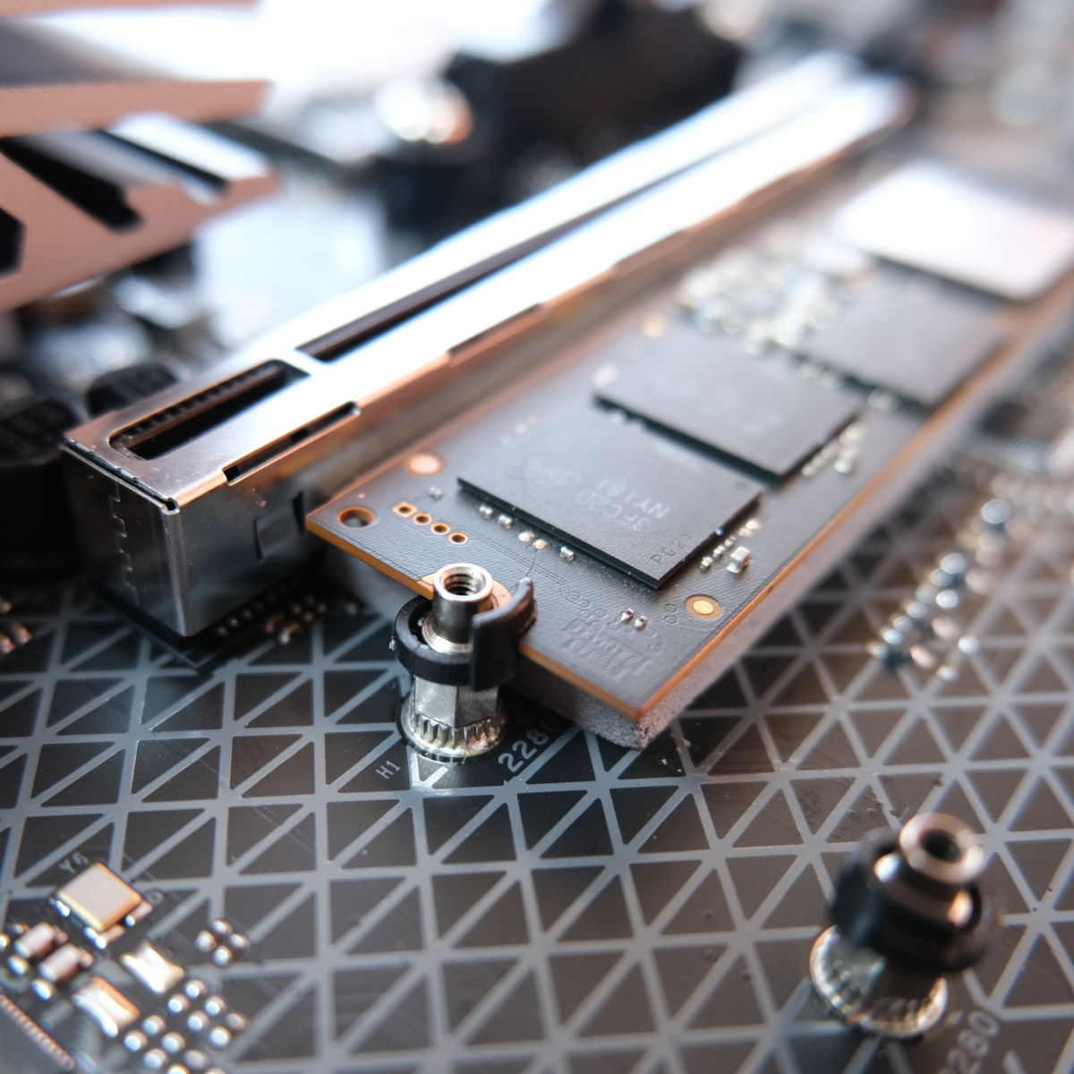 A close up of the SSD retention clips on Sapphire Nitro+ B850A WiFi 7.