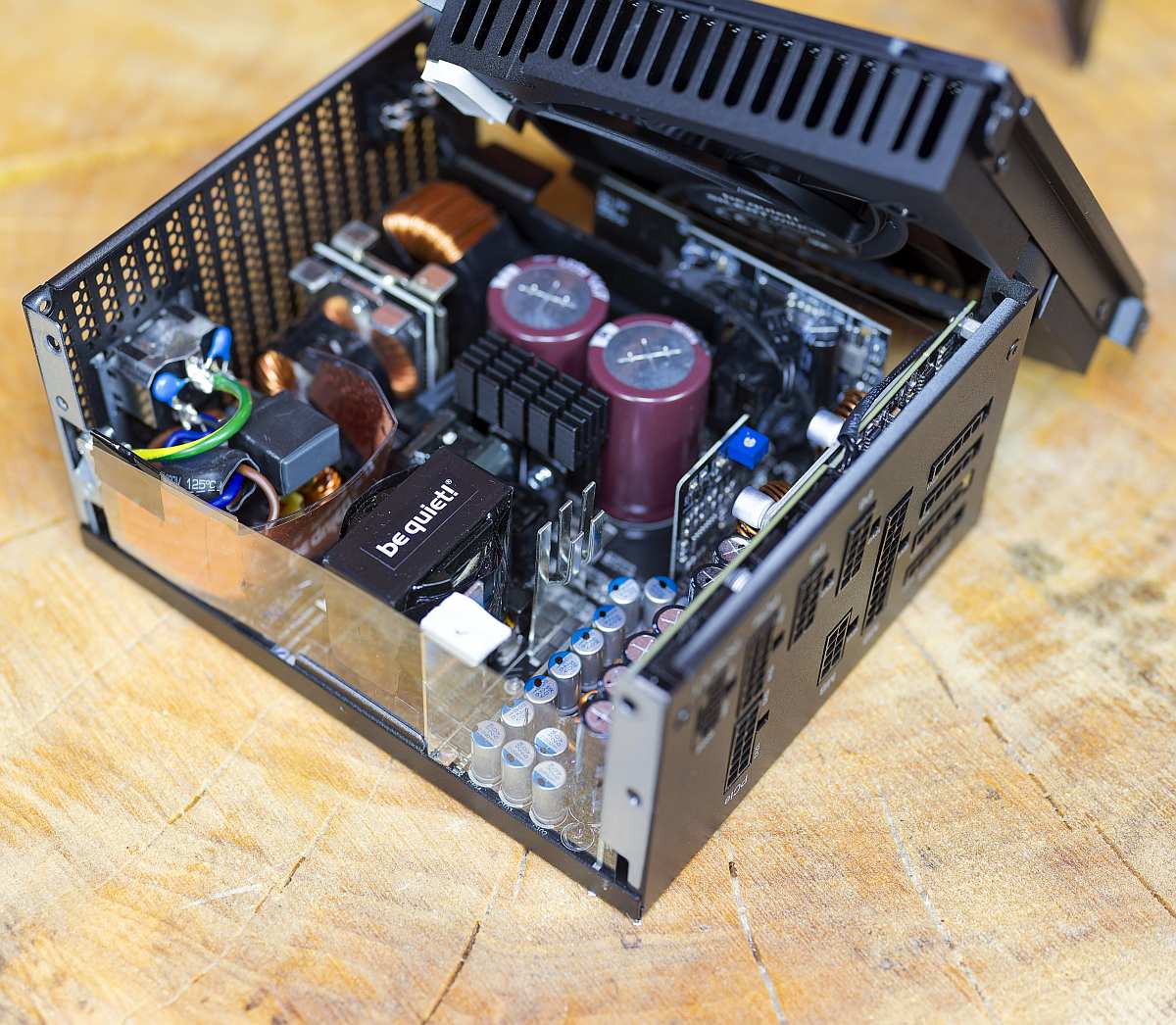 BQ Dark Power 14 1000W internals, on a wooden table, PSU, power supply unit