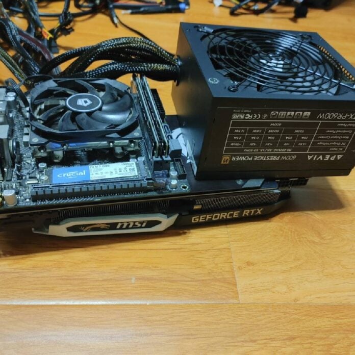 Selection of PC components in a pile on a wooden floor