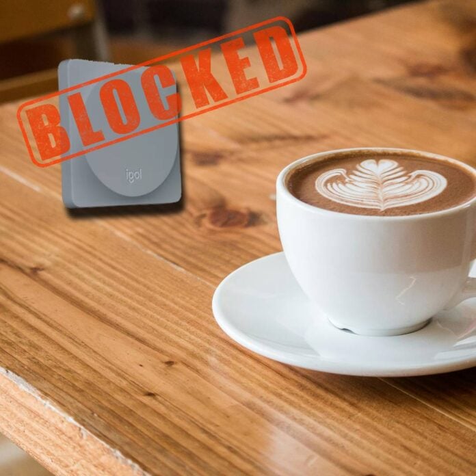 Logitech Pop button on a coffee table with a 'blocked' logo on top