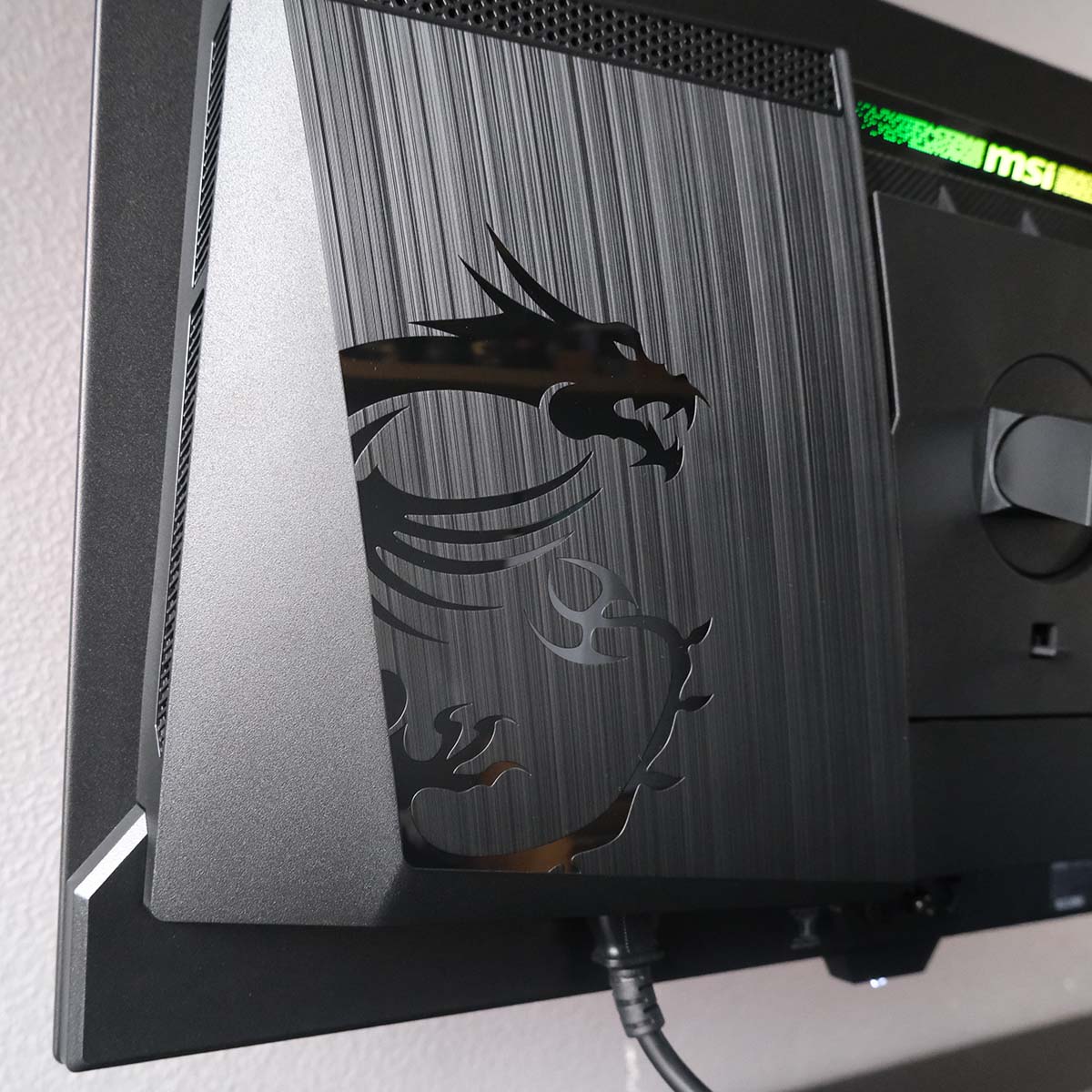 The dragon logo on the rear of MSI MPG 271QR QD-OLED X50.