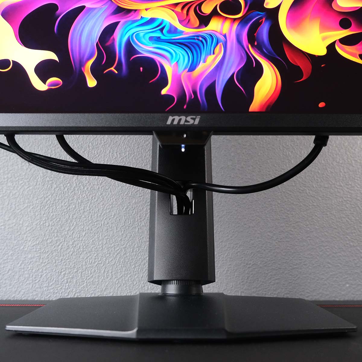 Cables protrude from the cutout in MSI MPG 271QR QD-OLED X50's stand.