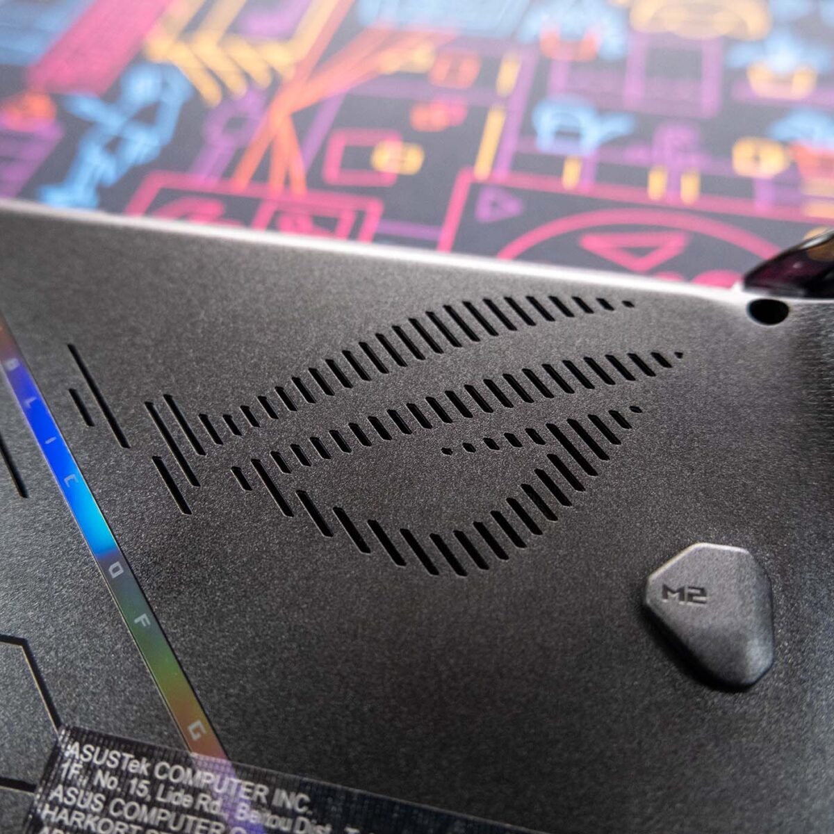 Close up of 'ROG' logo on ROG Xbox Ally X against a neon-style backdrop.