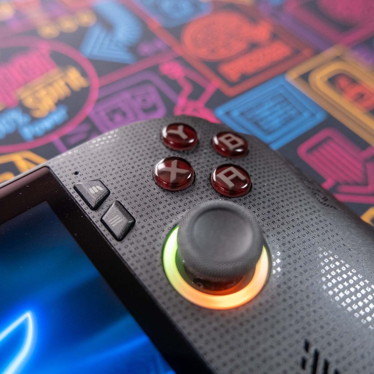 Close-up of right side buttons on ROG Xbox Ally X against a neon-style backdrop.