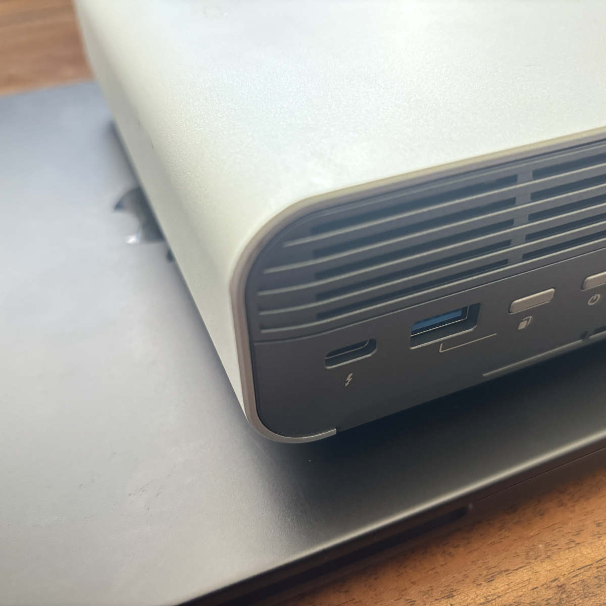 A picture of the QNAP all-flash NAS on a MacBook.