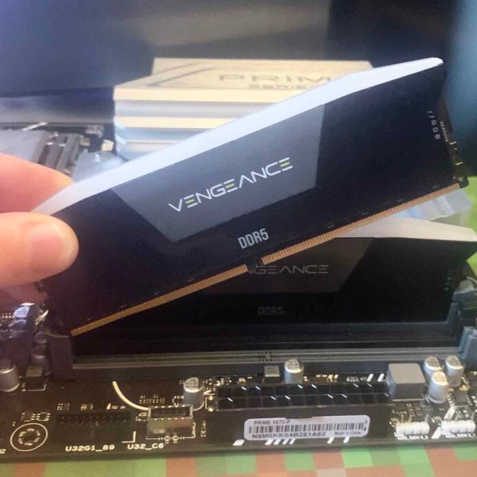 Corsair DDR5 RGB RAM being installed in motherboard.