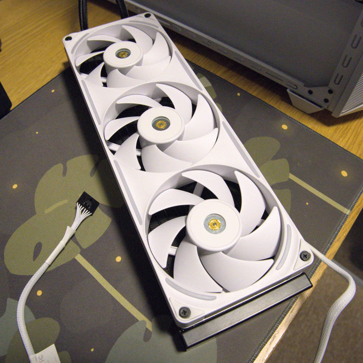 An NZXT F360X White installed atop an AIO water cooler.