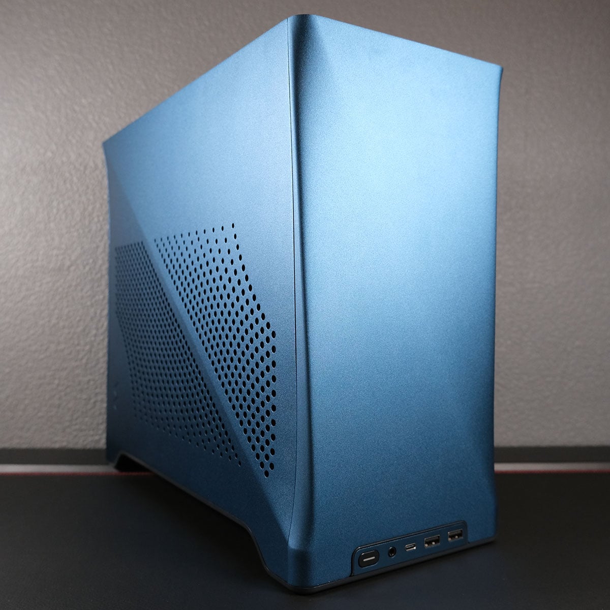 A side-on view of a blue Fractal Design Era 2 case.