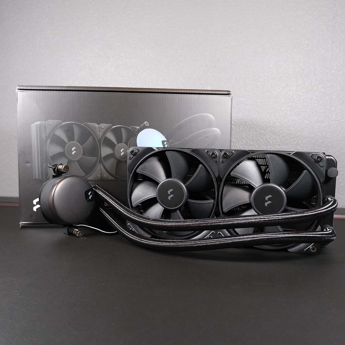 A Fractal Design Lumen S24 V2 AIO water cooler, resting in front of its retail packaging.