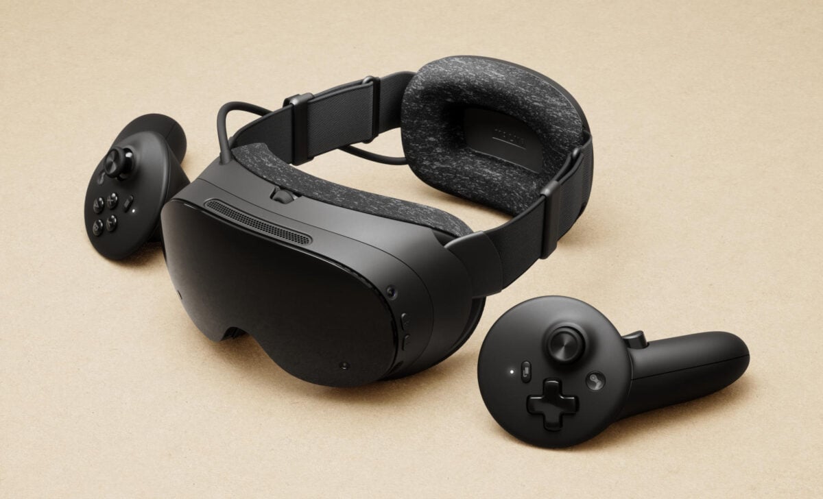 A Steam Frame headset surrounded by two controllers.