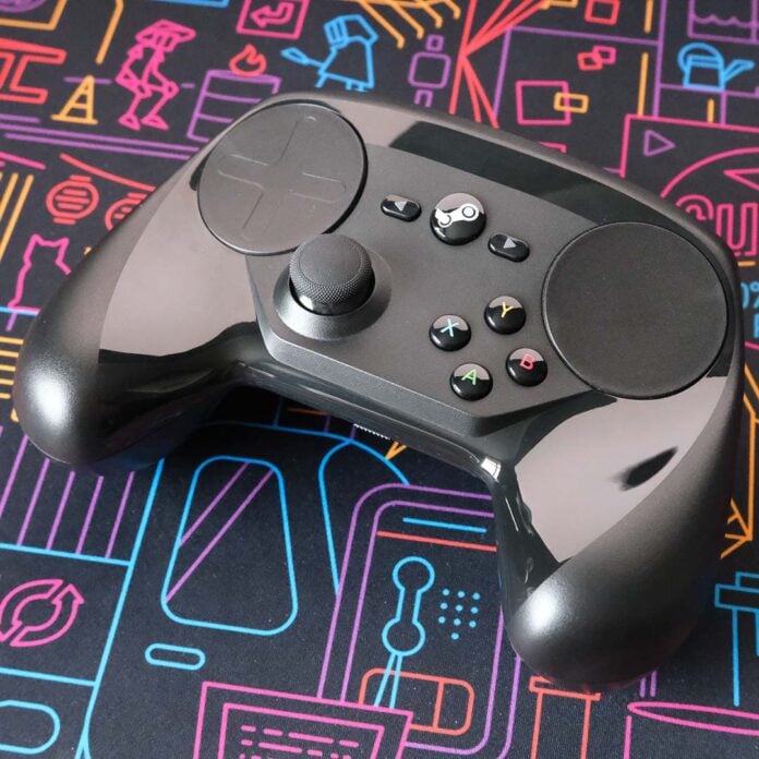 A Steam Controller, lying on its back atop a desk mat.