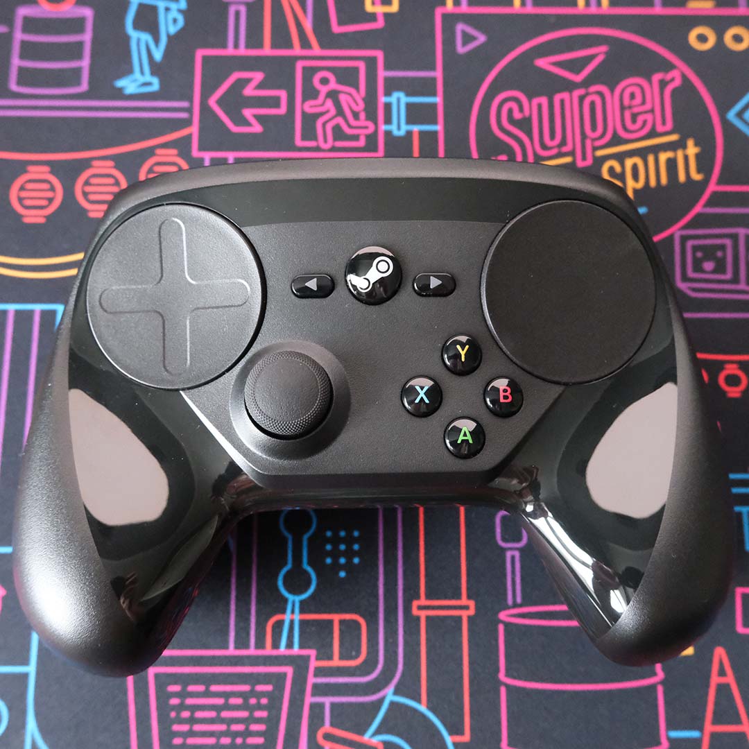 A Steam Controller, lying on its back atop a desk mat.
