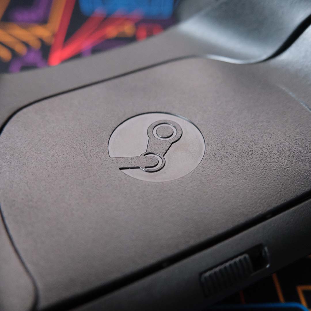 A close-up of the Steam logo on the back of a Steam Controller.