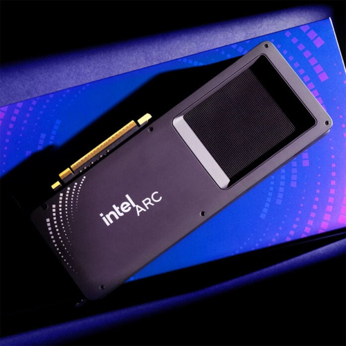 An Intel Arc graphics card, lies atop a blue box.