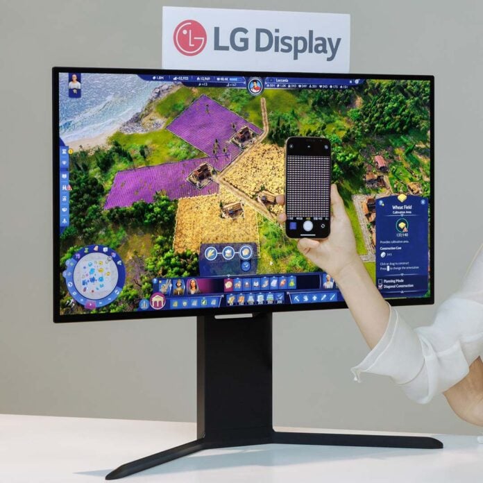 An LG OLED monitor, with a smartphone in front of it illustrating the new pixel layout.