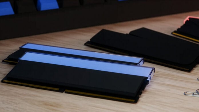 A collection of non-descript RAM sticks, resting on a wooden surface.