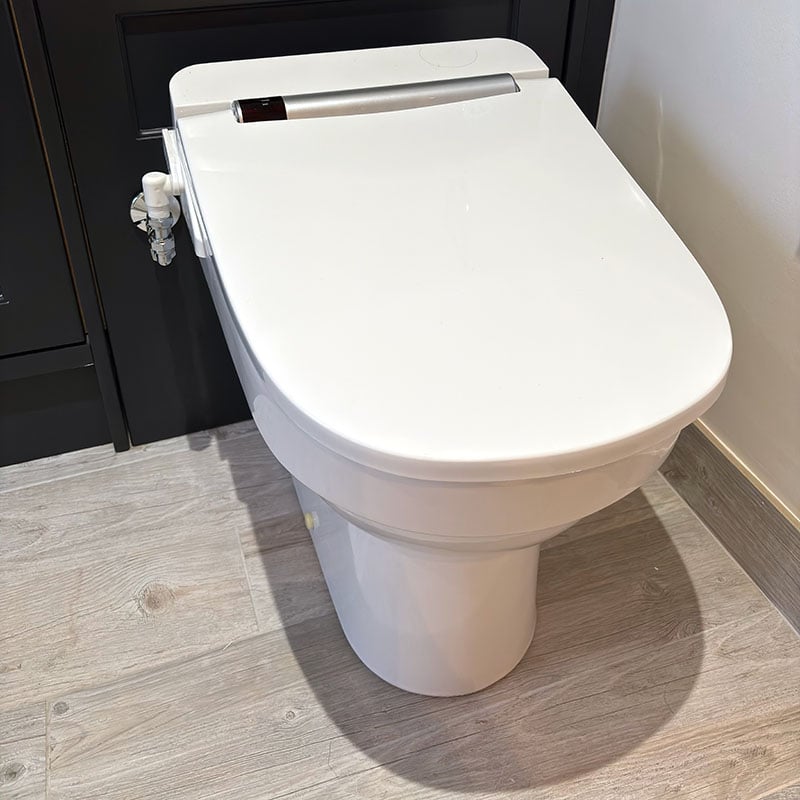 A picture of the VOVO VB-4100SR smart toilet seat installed on a white pan.