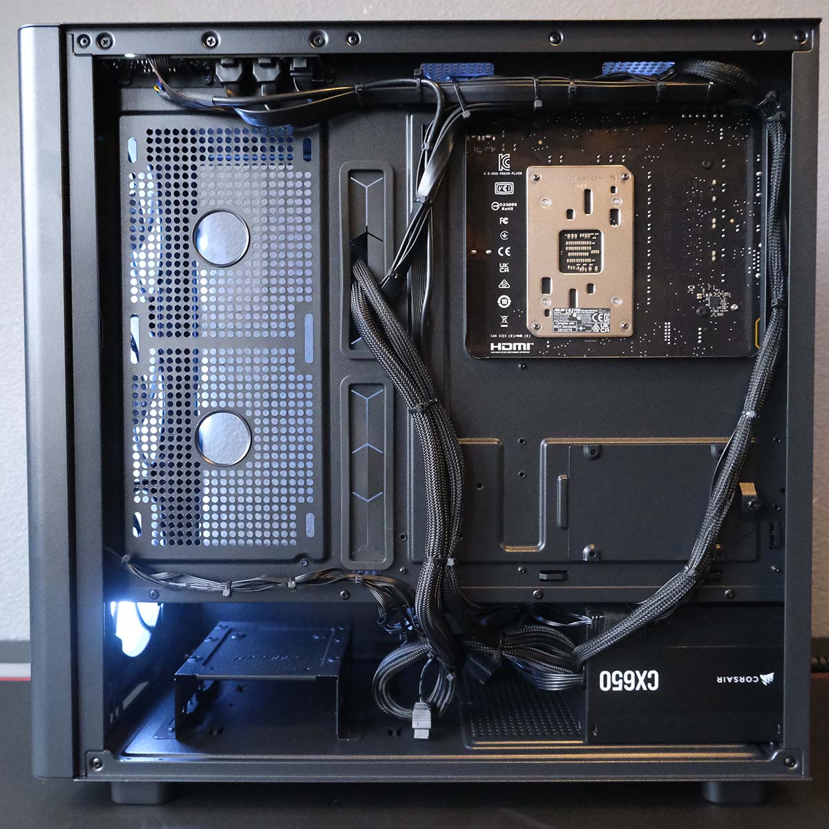 The PCSpecialist Aegis Pro R gaming PC, with its back panel removed, revealing cable management.
