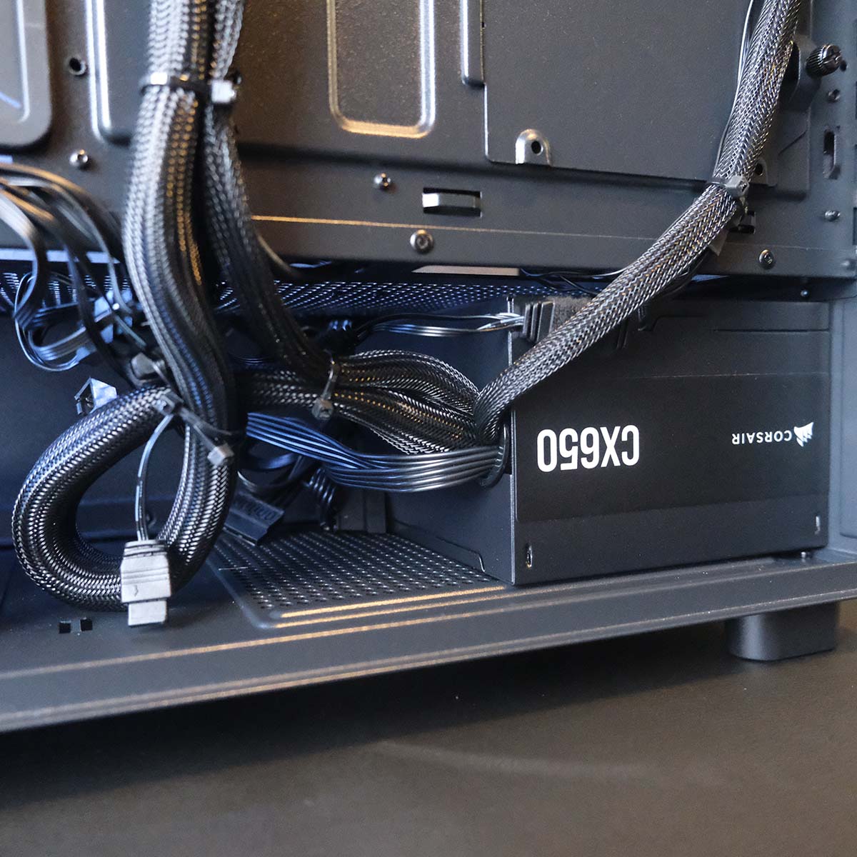 A close-up of the Corsair CX650 power supply inside the PCSpecialist Aegis Pro R gaming PC.