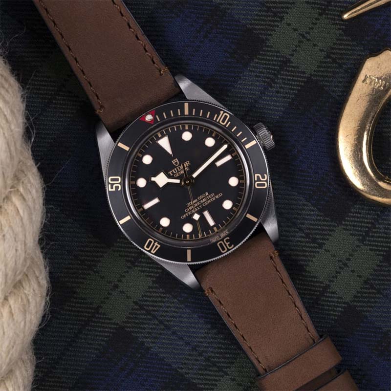 Tudor Black Bay 58 watch with 39mm steel case and brown leather strap.