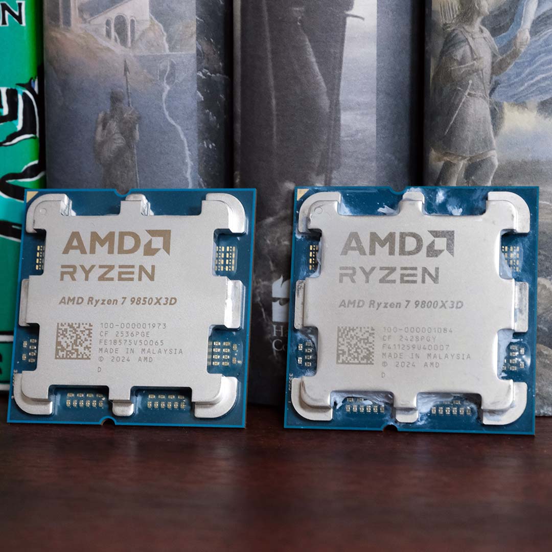 An AMD Ryzen 7 9850X3D (left) and Ryzen 7 9800X3D (right) resting against books.