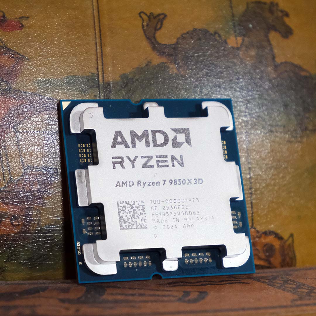 An AMD Ryzen 7 9850X3D processor, leaning against a globe.