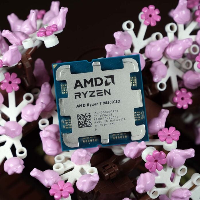 An AMD Ryzen 7 9850X3D processor, sat atop pink and white Lego flowers.
