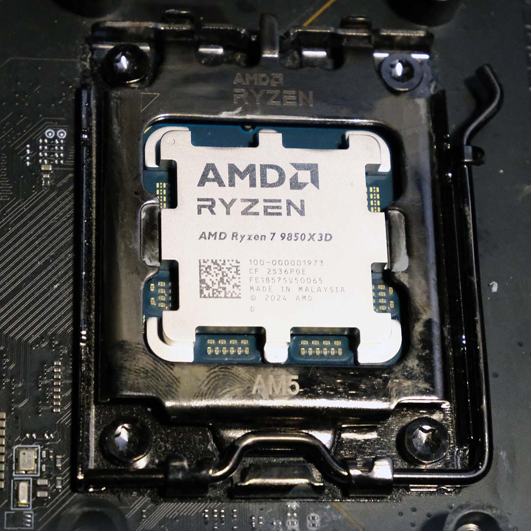 An AMD Ryzen 7 9850X3D inside a CPU socket.