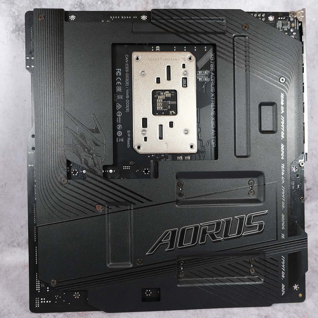 A top-down view of the Gigabyte X870E Aorus Xtreme X3D AI TOP motherboard's backplate, in its entirety.