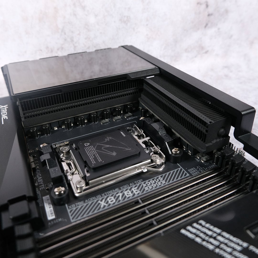 A wide shot of the top-half of the Gigabyte X870E Aorus Xtreme X3D AI TOP motherboard, showcasing its VRM heatsinks.