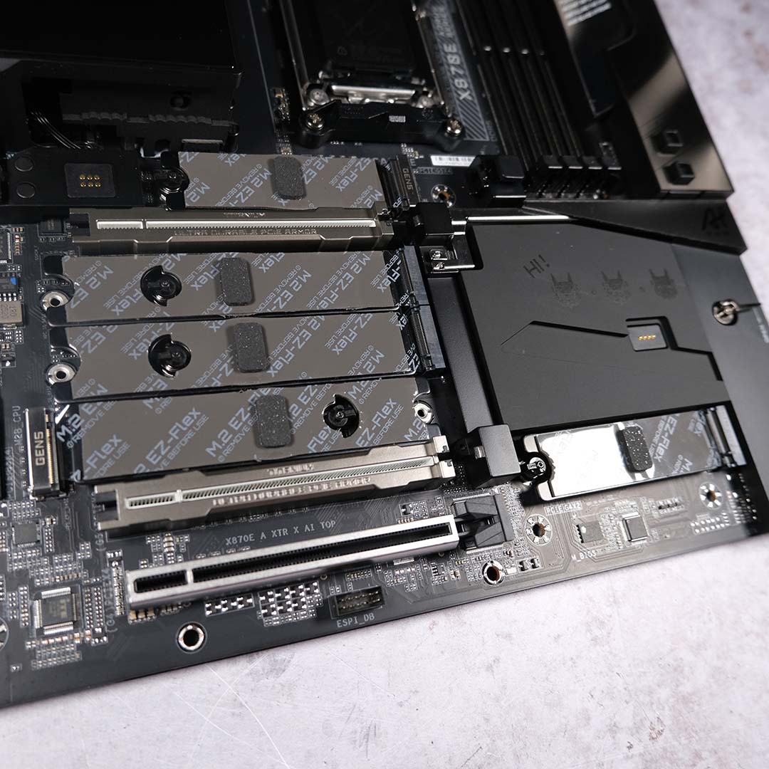A wide shot of the Gigabyte X870E Aorus Xtreme X3D AI TOP's lower half, showcasing its expansion slots for add-in cards and M.2 storage.