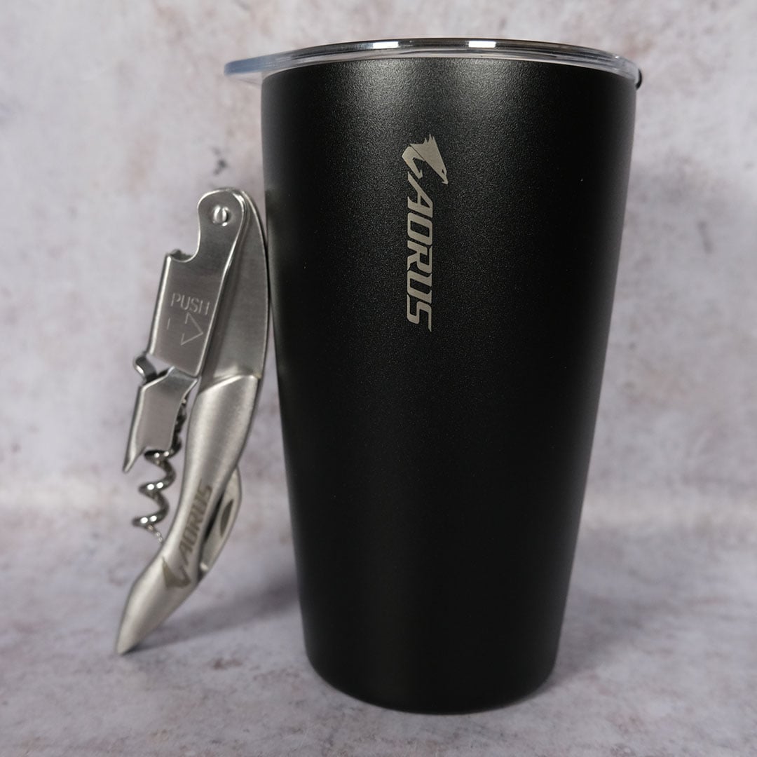 The bottle opener and tumbler, complete with Aorus branding, as packaged with the Gigabyte X870E Aorus Xtreme X3D AI TOP motherboard.