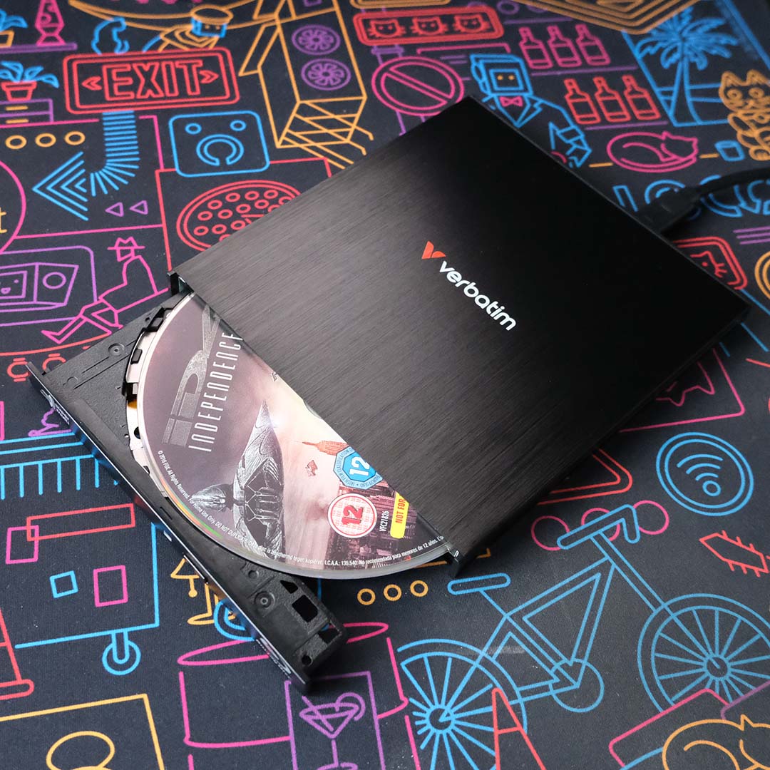 A disc drive, tray partially open, with a 4K Blu-ray inside it.