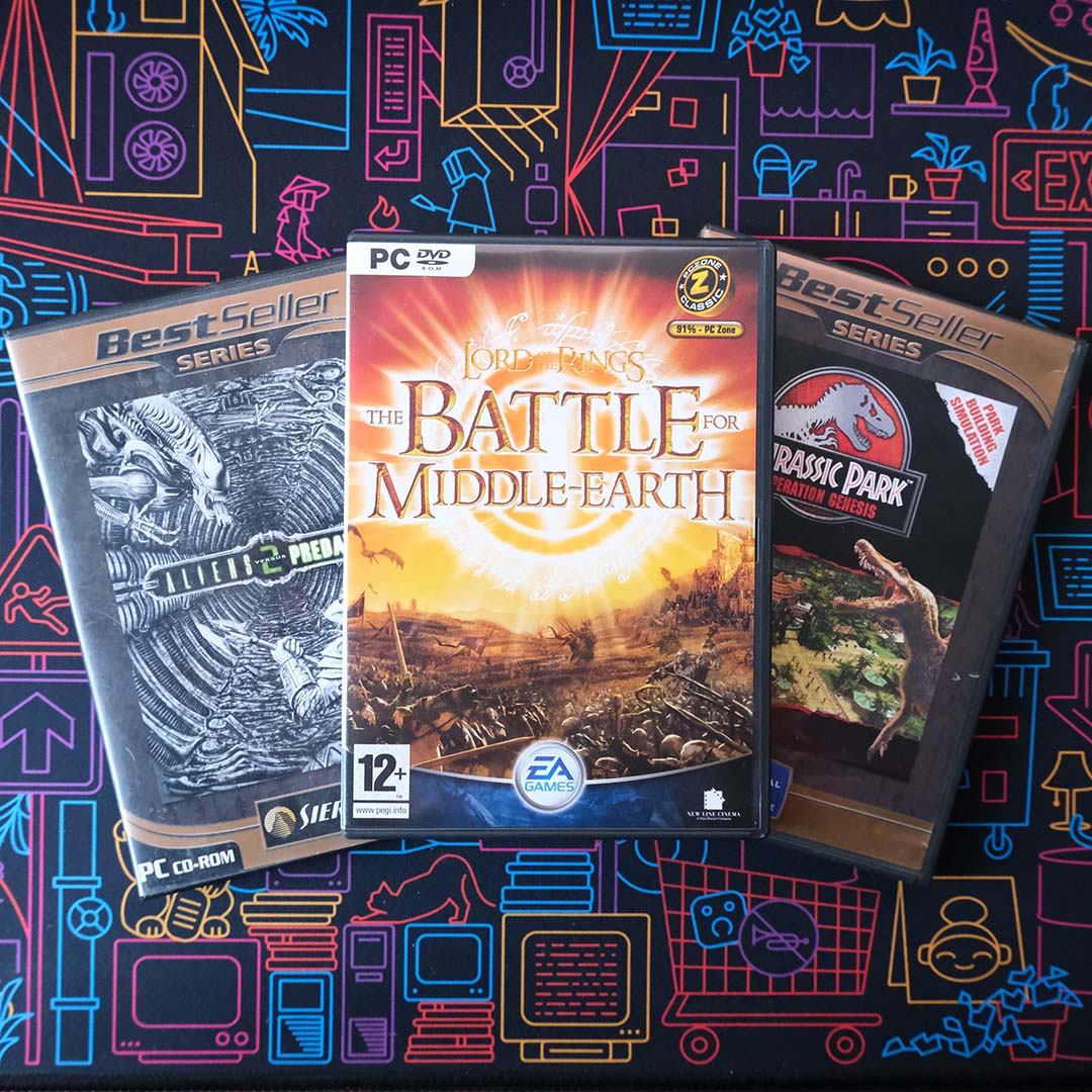A collection of three physical PC games, including Aliens Versus Predator 2 (left), The Lord of the Rings: The Battle for Middle-Earth (centre), and Jurassic Park: Operation Genesis (right).