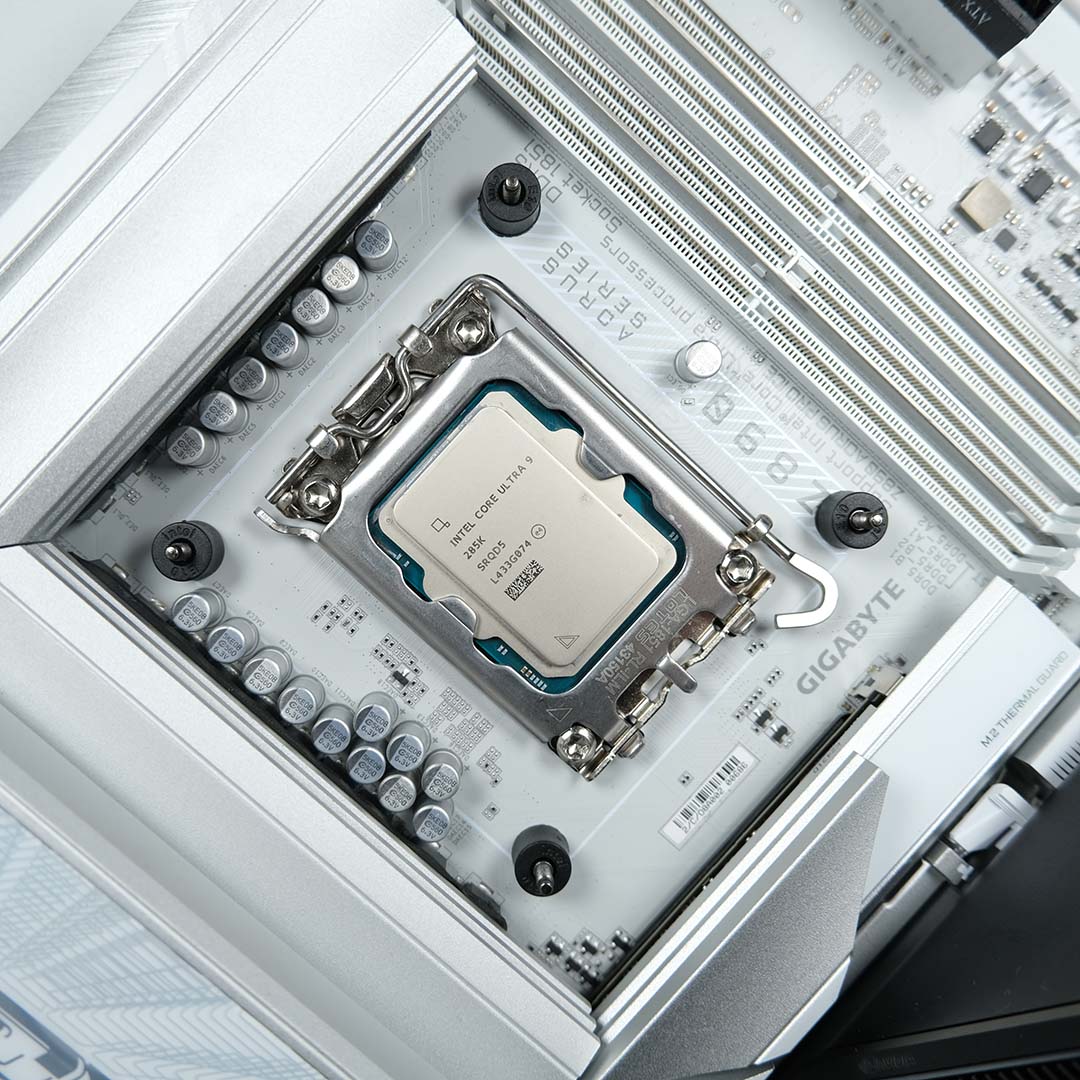 A top-down view of an Intel Core Ultra 9 285K inside a motherboard, surrounded by backplate mounts.