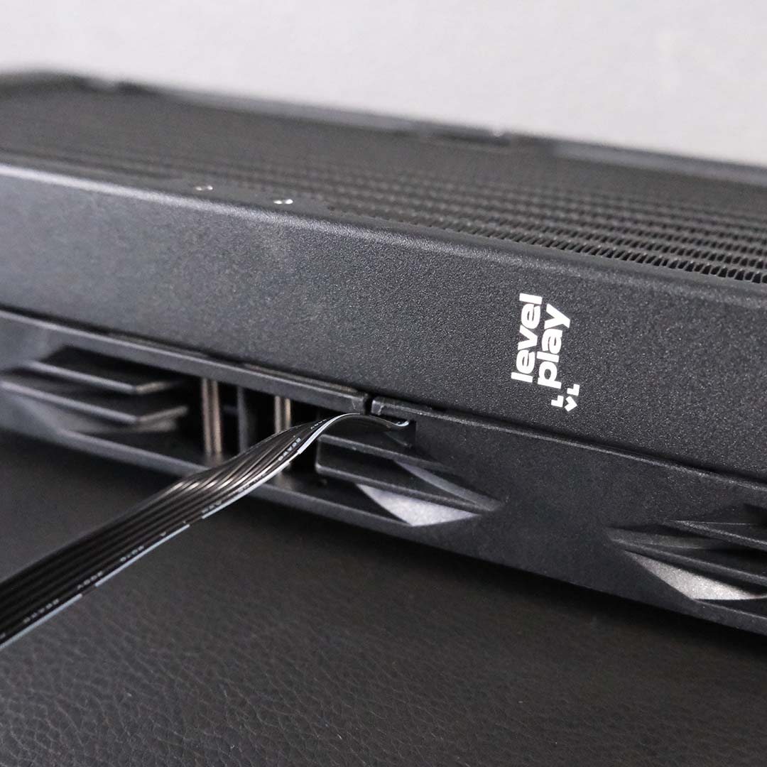 A close-up of the single cable design that comes out of the Levelplay Combat Liquid 360 HUD's fans.