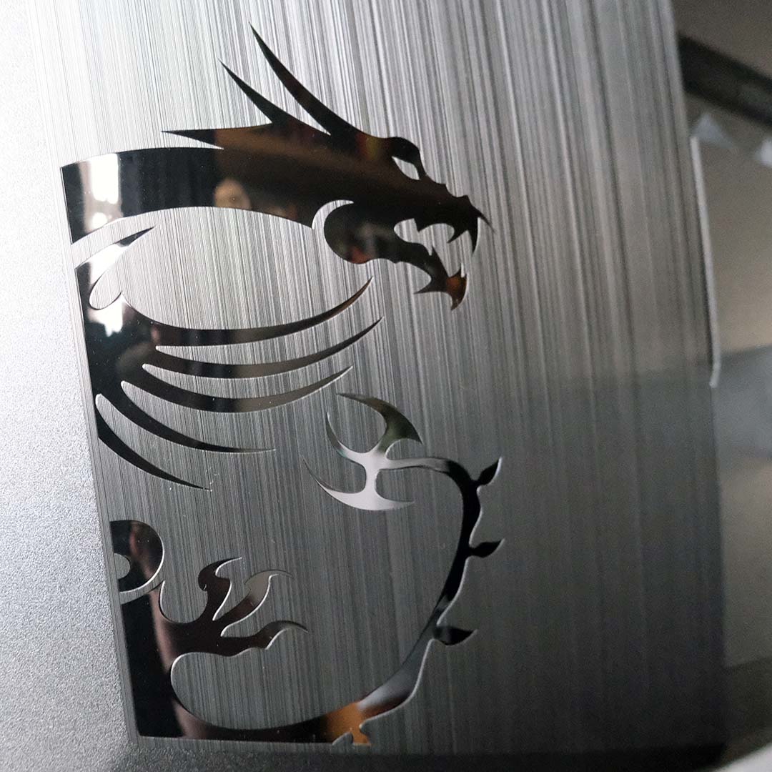 A close-up of dragon logo on the rear of the MSI MPG 341CQR QD-OLED X36.
